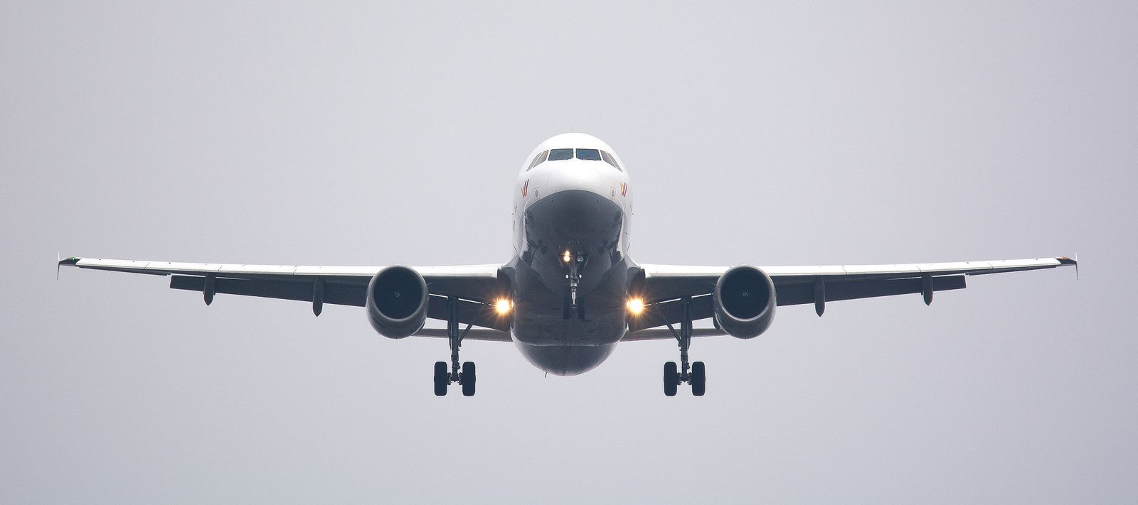 Commercial airliner on approach against an overcast sky